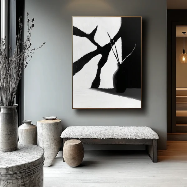 Minimalist oil painting: Black vase holding curved stems stands at lower right, casting shadow on surface. Angular white and charcoal-gray background planes with visible brush texture. No text or discernible words.